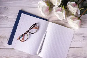 Open notebook, glasses, roses