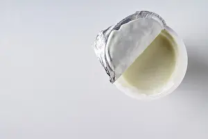 Open a package with yogurt on a white background