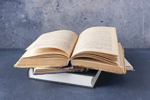 Open vintage book on blue background with copy space