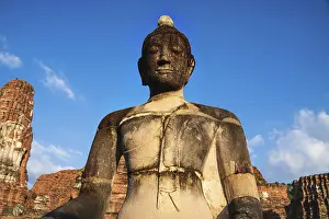 Orange colored buddha statue in temple Wat Nok during sunset in Ayutthaya