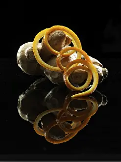 Orange peel, ginger tuber, fruit and vegetable decoration on black background