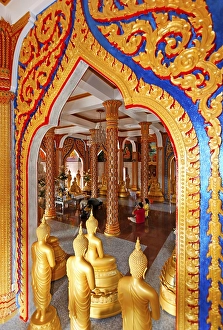 Ornate gate and golden Buddha statues