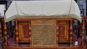 Ornate wooden construction with historical inscription
