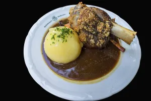 Oven-fresh Schaeuferle, knuckle of pork with potato dumpling