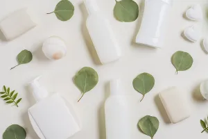Overhead view cosmetics products soap bath bomb green leaves