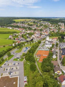 Overview of a village with tennis courts and green