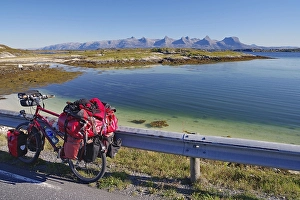 Packed touring bike, crystal clear water in a shallow bay