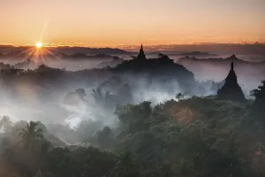 Pagodas surrounded by trees, at sunrise
