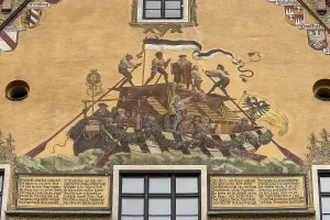 Painted facade with a boat and people on the Danube at Ulm Town Hall from the 15th century