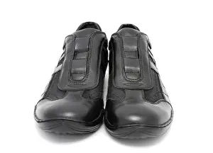 A pair of black mens sports shoes over white background