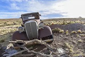 Pampa with old car on a farm in Bosques Petrificados de Jaramillo National Park