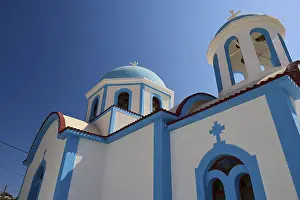 Panagia Evangelistria, Greek Orthodox church with blue domes and sunny surroundings