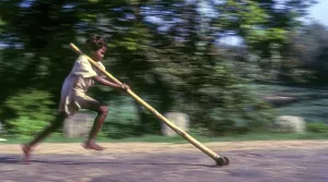 Panning, Tribal boy playing improvised pulley in balle