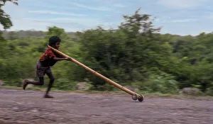 Panning, Tribal boy playing improvised pulley in balle