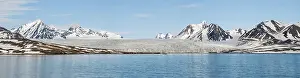 Panorama of glacier above the sea with the mountains behind