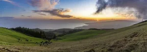A panorama picture of the sun setting over the S