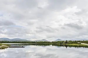 Panorama of Ringebu Kommune with view on a lake and the moutains of Rondane national Park in Oppland Norway