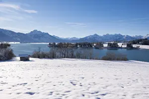 Framed Print : Panorama of a snowy field with lake and mountains under a clear blue sky