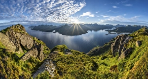 Panorama, sun shining on Fjord Raftsund and mountains