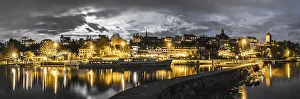 panorama view of the Swiss city Murten and harbor skyline at night under a full moon