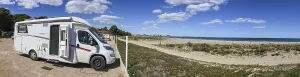 Panoramic photo campsite Camping Cala D'Oques with motorhome in front row to the beach and sea