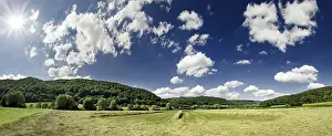 Panoramic view of a hay meadow and cloudy sky
