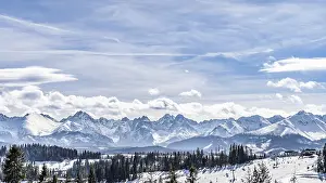 Panoramic view on snowy forest and Tatra Mountains in winter time
