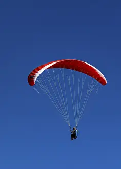 Paragliders against a blue sky