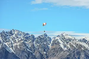 Paragliding over the snowcapped Remarkables mountain range