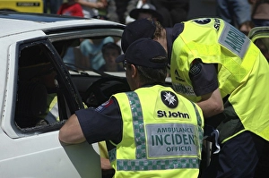 Paramedics check patient in a wrecked vehicle