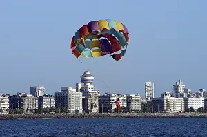 Parasailing one man with colourful parachute on Chowpatty