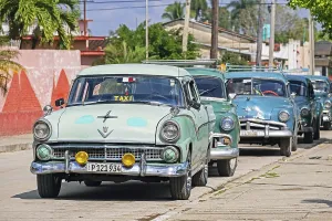 Parked American classic cars used as Cuban taxis in the town Jatibonico