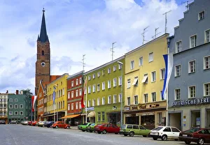 Parking cars, town square with the Gothic parish church of St