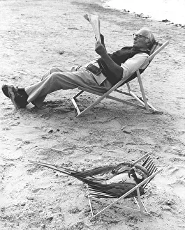 Parrot and man in deck chair, England