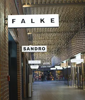 Framed Print : Passage with decorative fairy lights and shops such as Falke and Sandro