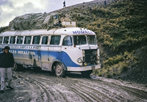 Passengers walk as Morales Mofalito's bus to La Paz slips in the mud on a difficult stretch of road, Bolivia, South America, 1962, South America