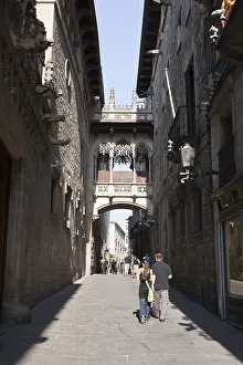Passers-by under the Bridge of Sighs in Carrer del Bisbe