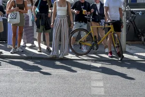 Passers-by waiting at a pedestrian crossing