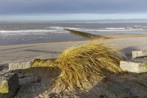 Paved beach promenade and groyne on the west beach of Norderney