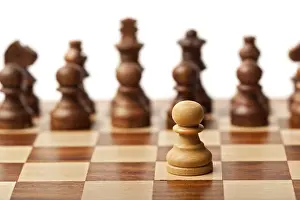 One pawn agains all, wooden chess pieces on chessboard