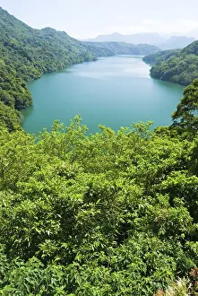 Peaceful lake surround by forests and mountains