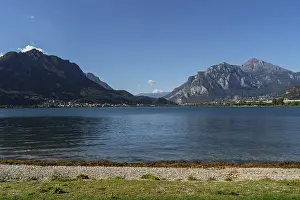 Peaceful lakeside beach with pebbles and grassy shoreline