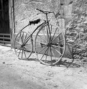 Pedal crank wheel leaning against a wall