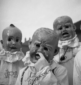 People with baby masks, carnival