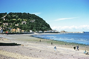 People on the beach with a view of North Hill, Minehead, Somerset, England, Great Britain in the early 1960s