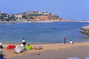 People, boats, Sant Feliu de Guixols beach on the Costa Brava