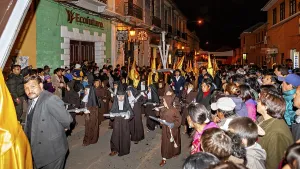 People in brown hooded cloaks with crosses