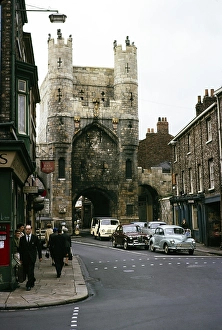 People and cars on the road near Monk Bar, York, Yorkshire, England, 1963