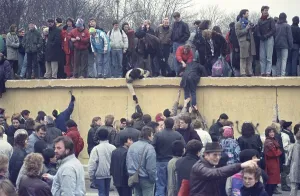 People climbing the Berlin Wall at Brandenburg Gate