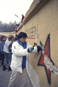 People climbing the Berlin Wall at Brandenburg Gate